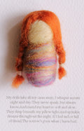 Textile doll with colorful hair on a white background